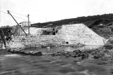 The partly completed Masonry Dam. The coffer dam is flooded. c.1897.